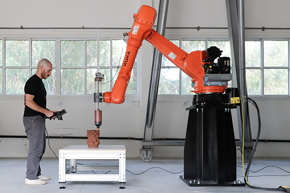 Manufacturing a bioclimatic envelope prototype with a robotic setup for 3D Printing, comprising a 6-axes industrial robotic arm and ram-extrusion end-effector.